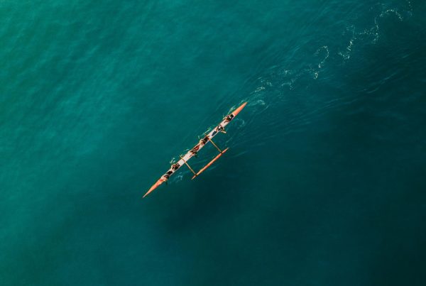 Canoe and crew in ocean from above